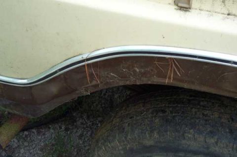 1979 Ford Bronco - Close-up of a rusty wheel well on a vintage Ford Bronco, showing signs of wear and tear.