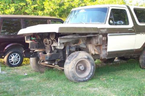 1979 Ford Bronco - Ford Bronco in need of repair, front end disassembled, with another vehicle behind it.