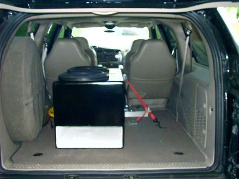 2000 Ford Excursion - The interior of a 2000 Ford Excursion shows a subwoofer box and spare tire in the cargo area.