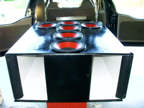 2000 Ford Excursion - Custom speaker box with six red-and-black speakers installed in the rear of a vehicle.