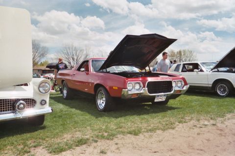 1972 Ford Ranchero - A red 1972 Ford Ranchero is displayed with its hood open at an outdoor car show.