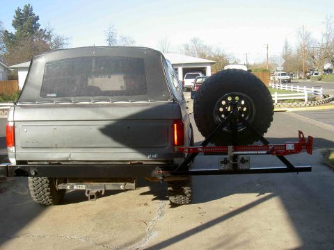 1987 Ford Bronco - Rear view of a 1987 Ford Bronco showing a custom bumper and spare tire carrier assembly.
