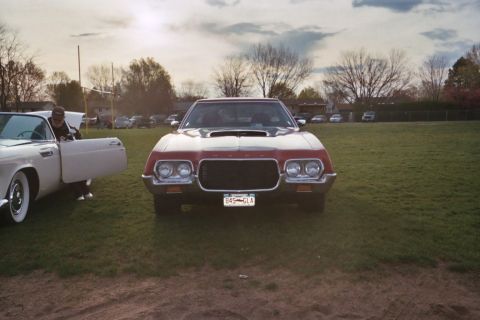 1972 Ford Ranchero - A 1972 Ford Ranchero is displayed at a car show with other vehicles in the background.