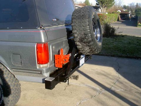 1987 Ford Bronco - Rear view of a gray 1987 Ford Bronco a custom bumper and spare tire carrier.