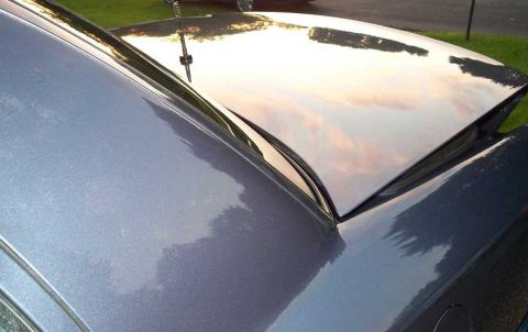 1998 Ford Crown Victoria - The reflection on the car's hood shows a cloudy sky at sunset. A watermark is visible in the lower right corner.