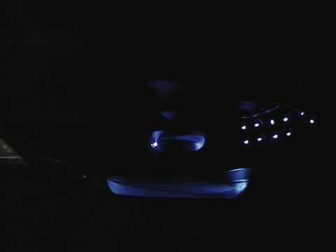 1999 Ford Taurus - A close-up shot of illuminated interior car lights against a dark background.