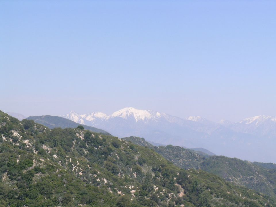 Mountain range with snow-capped peaks under a clear blue sky