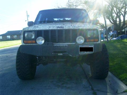 1986 Ford Bronco - This Jeep Cherokee is seen from the front, modified with a heavy-duty bumper and off-road tires.