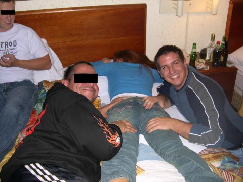 1997 Ford Probe - A group of people are gathered on a bed in a hotel room, with bottles on the nightstand.
