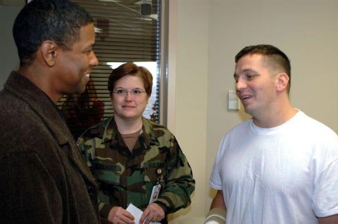 1996 Ford Probe - A man in a brown jacket talks with a woman in military camouflage and another man in a white t-shirt.