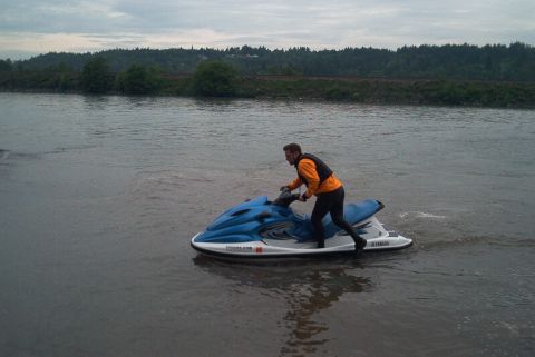 2004 Yamaha XL700 3-Pass - A person rides a blue and white 2004 Yamaha XL700 3-Pass jet ski on a body of water.