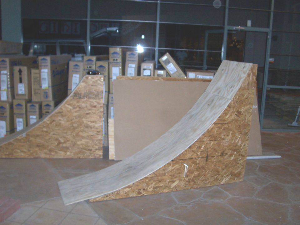 wooden ramps set up indoors, boxes stacked in background