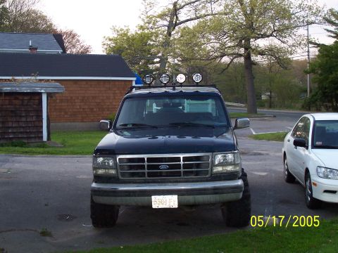 1994 Ford Bronco - Front view of a 1994 Ford Bronco equipped with auxiliary lights on the roof rack.