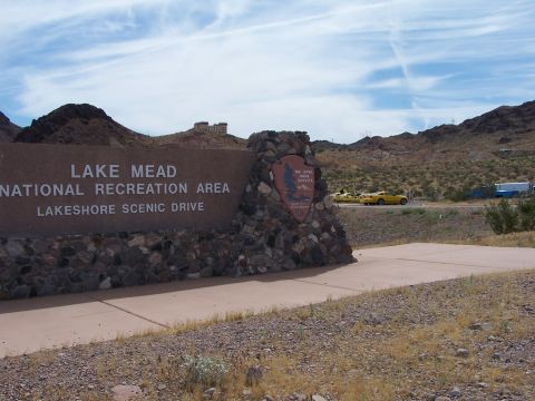2002 Ford GT - Two yellow sports cars are visible in the distance near the Lake Mead National Recreation Area entrance.