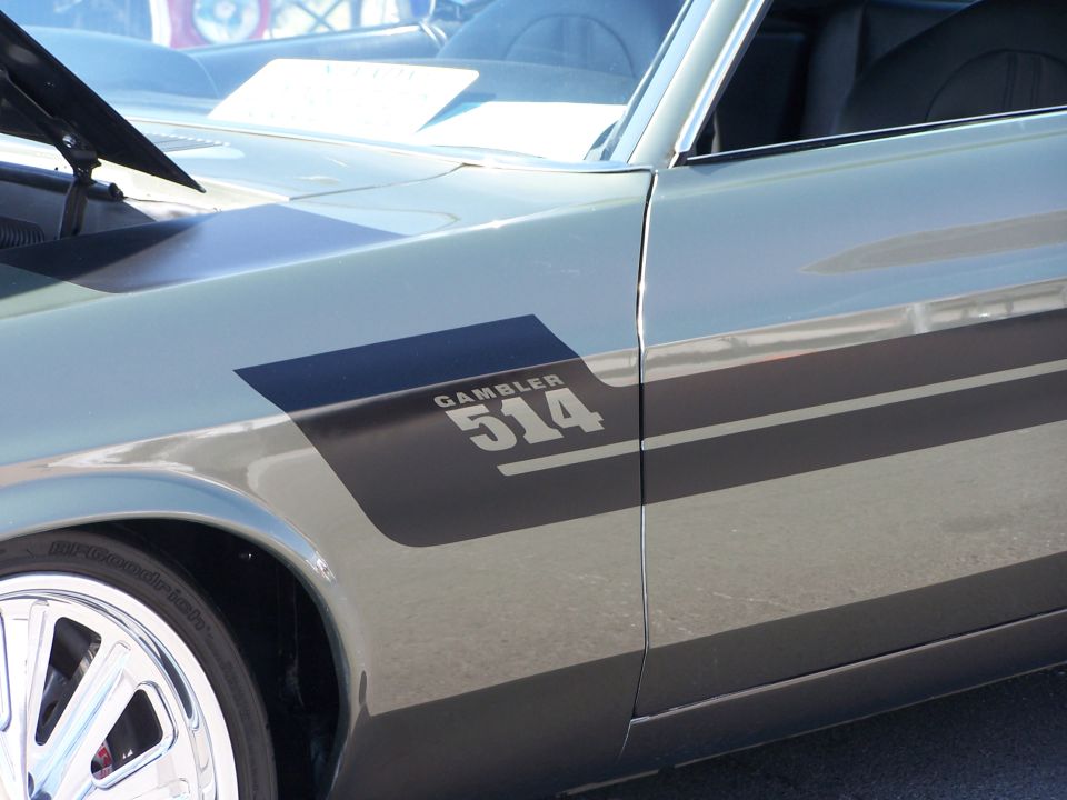 Car fender with black stripe and 'GAMBLER 514' text. Chrome wheel visible