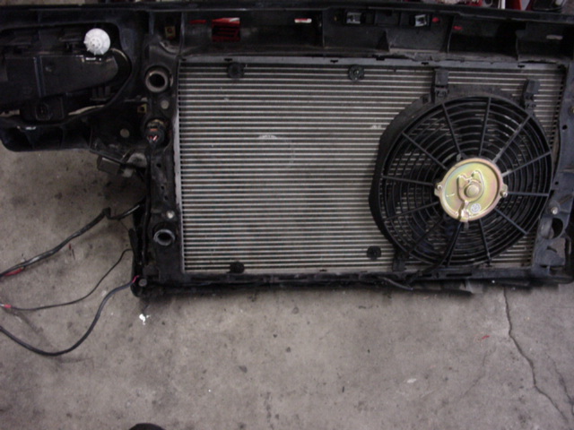 Radiator and fan assembly with wiring. Supermotors.net logo visible