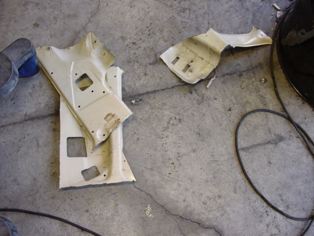 Car body panels on concrete floor with Supermotors.net watermark