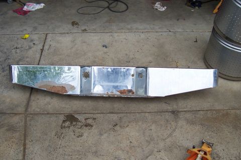 1994 Ford F-150 - This chrome rear bumper shows signs of rust and wear, with visible mounting holes for a license plate.
