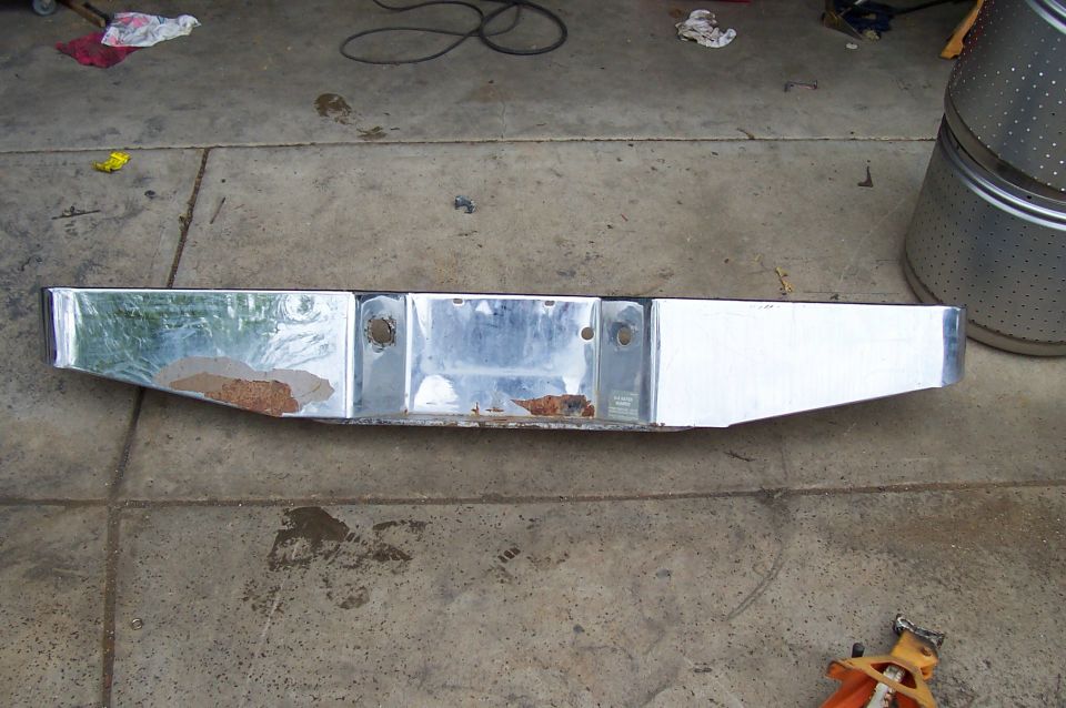 Chrome rear bumper with rust spots and license plate mounting holes
