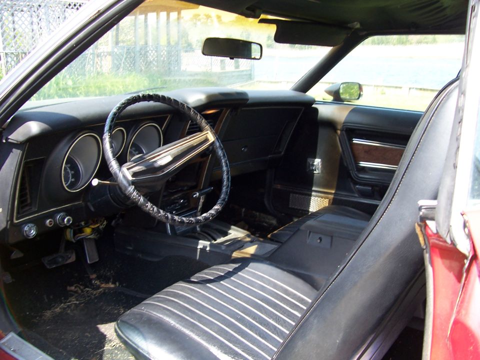 1971 Ford Mustang interior showing dashboard, steering wheel, and seats