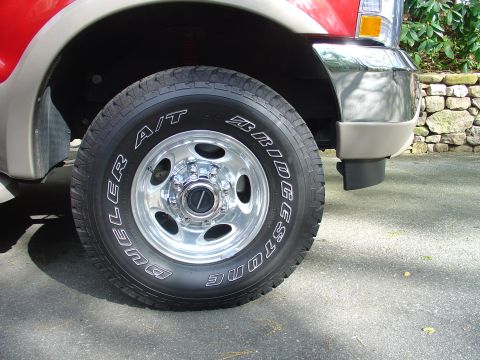 2002 Ford Excursion - Close-up of the front wheel and fender of a 2002 Ford Excursion.