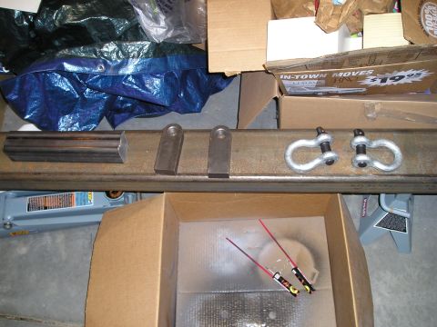 1996 Ford Bronco - Parts for a custom bumper project are laid out, including shackles and mounting hardware.