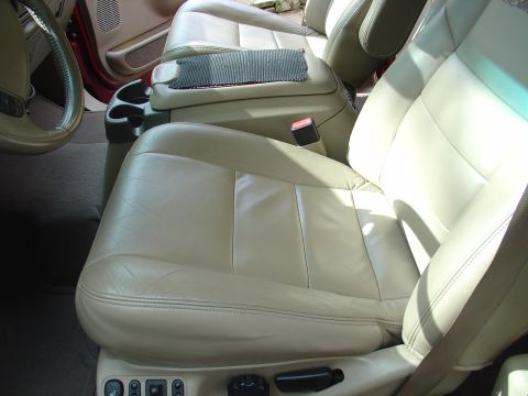 2002 Ford Excursion - Interior view of tan leather seats and center console in a 2002 Ford Excursion.