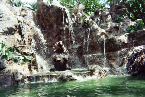 1968 Ford Mustang - A man-made waterfall cascades over rocks, with an elephant statue positioned in the center.