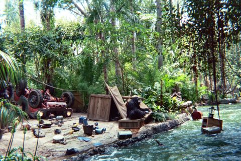 1968 Ford Mustang - A jungle scene depicts an overturned vehicle, crates, and a chimpanzee near a flowing river.