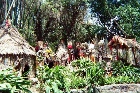 1968 Ford Mustang - A jungle scene features thatched huts and figures dressed in traditional attire.