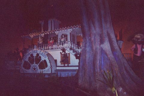 1968 Ford Mustang - The Topsy-Dee Lady riverboat is illuminated at night, decorative lights and figures visible on its decks.