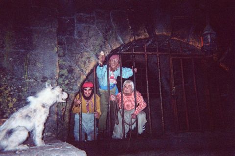 1968 Ford Mustang - Animatronic figures appear to be imprisoned behind bars, with a creature resembling a dog standing guard.