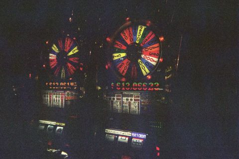 1968 Ford Mustang - Two slot machines with spinning wheels are visible in a dimly lit casino.