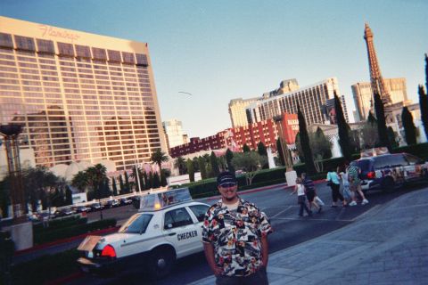 1968 Ford Mustang - A man poses for a photo with the Las Vegas Strip skyline and a Checker taxi in the background.