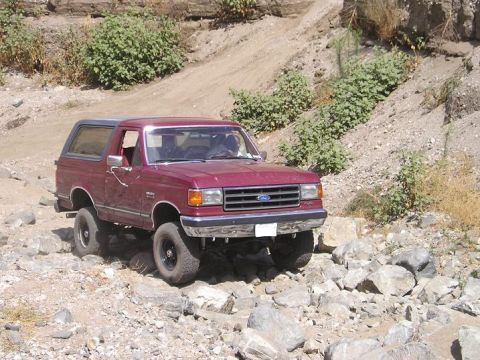 1989 Ford Bronco - This 1989 Ford Bronco tackles a challenging off-road course with its tires gripping the rocks.