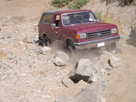 1989 Ford Bronco - 1989 Ford Bronco tackling rough terrain off-road.