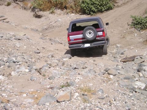 1989 Ford Bronco - This Ford Bronco navigates a challenging, rocky off-road path.