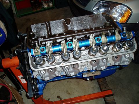 1966 Ford Fairlane - Close-up of a V8 engine assembly, blue performance parts and a black oil-pan.