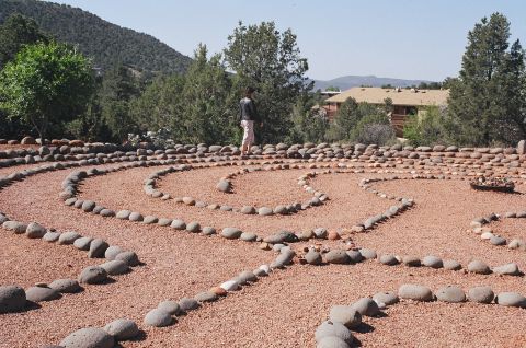 1994 Ford Bronco - A person stands within a circular stone labyrinth in a desert landscape, with a Supermotors.net logo in the lower right corner.