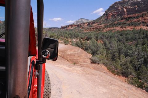 1994 Ford Bronco - Driving on an off-road trail through a scenic desert landscape with red rock formations.