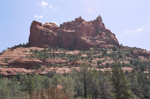 1994 Ford Bronco - Scenic view of red rock formations and surrounding vegetation under a bright blue sky.