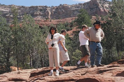 1994 Ford Bronco - Group of people exploring a scenic, rocky outdoor environment with sparse vegetation.