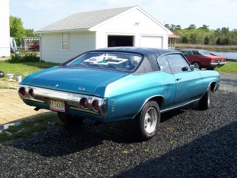 1971 Chevrolet Chevelle - Teal 1971 Chevrolet Chevelle coupe with black vinyl top parked in a driveway, with another car in the background.