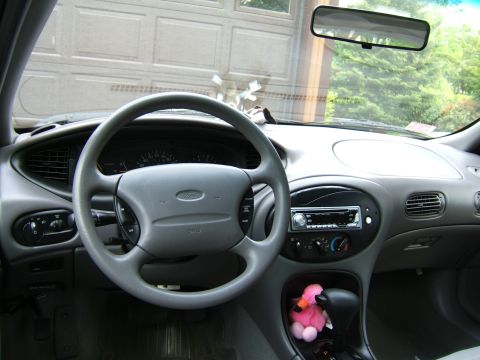 1998 Ford Taurus - Interior view of a 1998 Ford Taurus, showing the steering wheel, dashboard, and gear shifter.