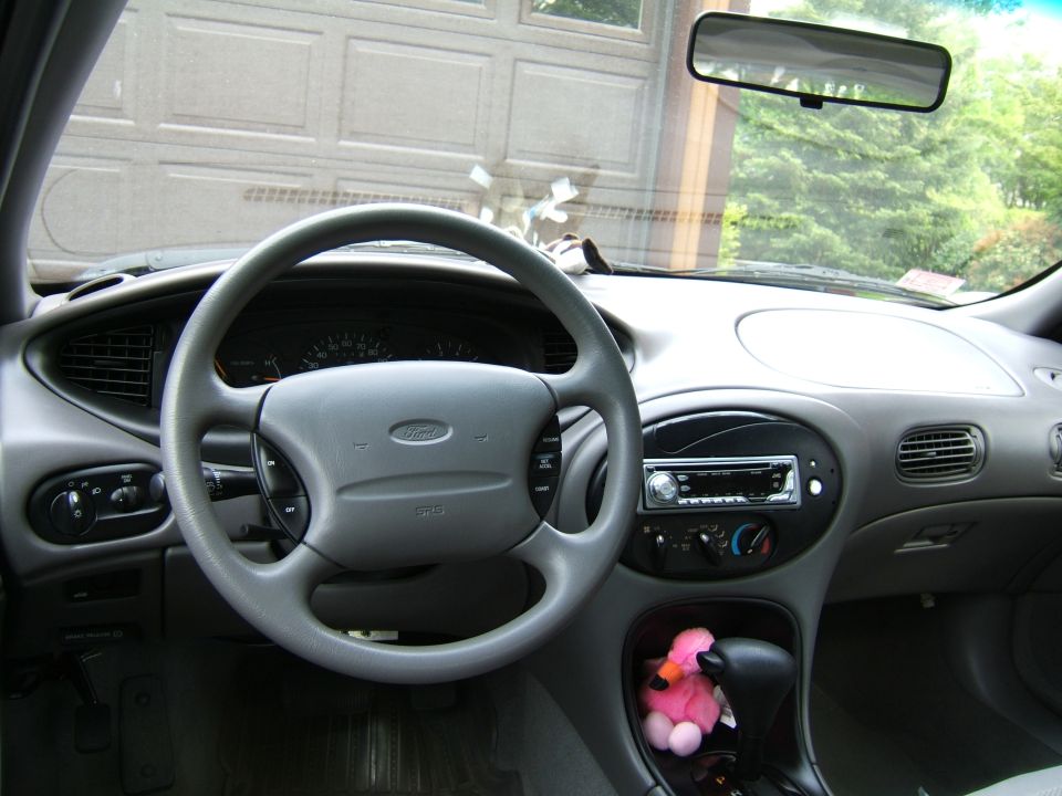 1998 Ford Taurus interior with steering wheel, dashboard, and center console