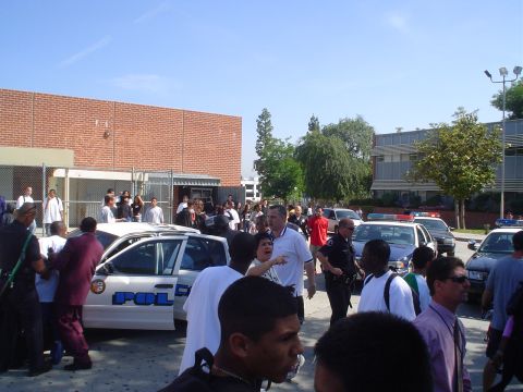 1993 Ford Taurus - A chaotic scene unfolds around a police car, with officers and civilians gathered.