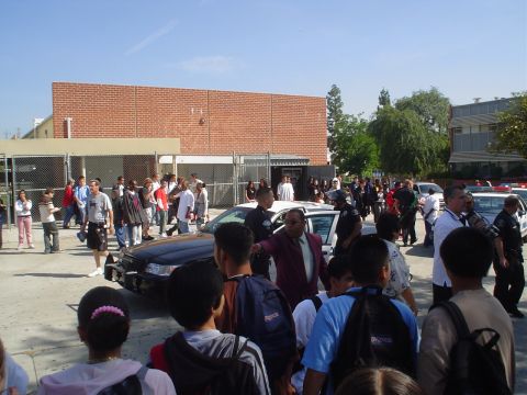 1993 Ford Taurus - A 1993 Ford Taurus police car is seen with a crowd of people gathered around it.