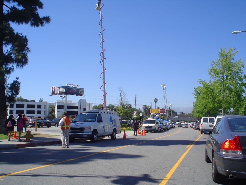 White broadcast van with antenna tower, side view
