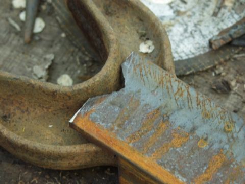 1979 Ford Bronco - A close-up view of a heavily rusted metal component, showing signs of wear and damage.