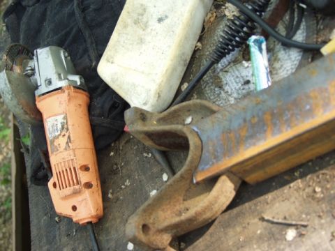 1979 Ford Bronco - Tools and metal parts are laid out on a workbench, suggesting a repair or fabrication project.